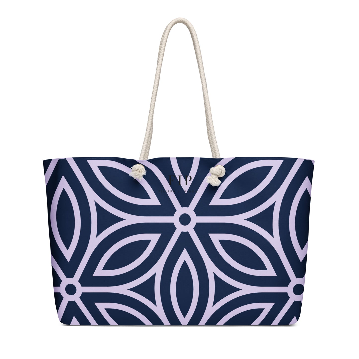 A tote bag with a navy blue and light purple geometric pattern, featuring thick off-white rope handles.