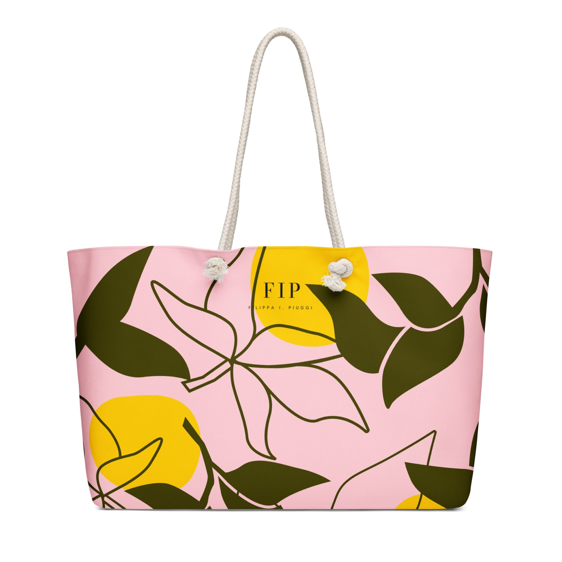 A pink tote bag with a yellow and dark green botanical pattern, featuring white rope handles and a small white flower accent near the top. 