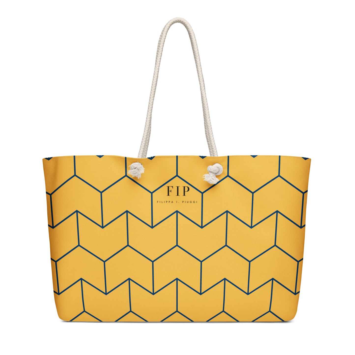 A yellow tote bag with a navy blue geometric cube pattern, featuring two white rope handles. 
