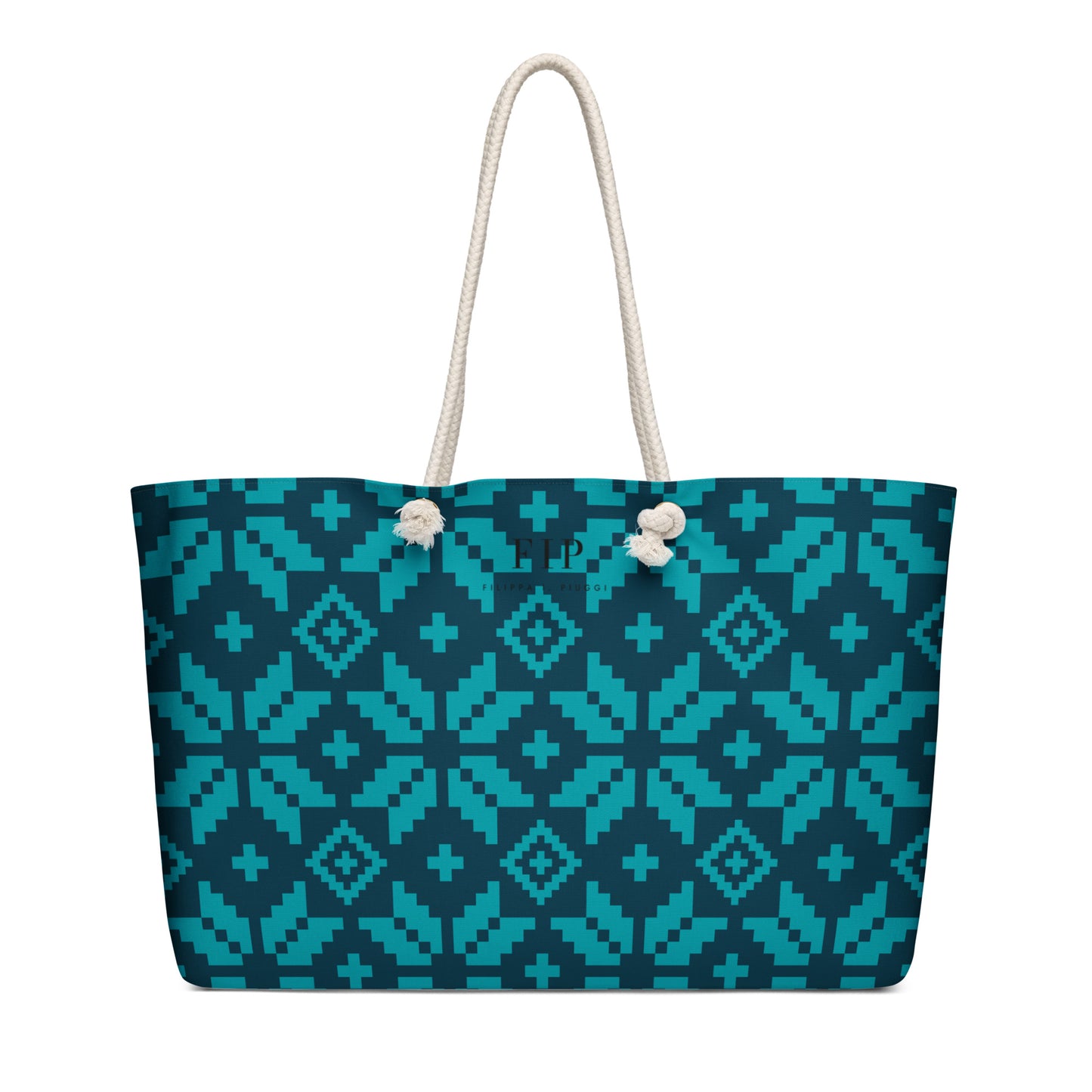 A tote bag with aztec pattern in teal and dark blue, featuring off-white rope handles. 