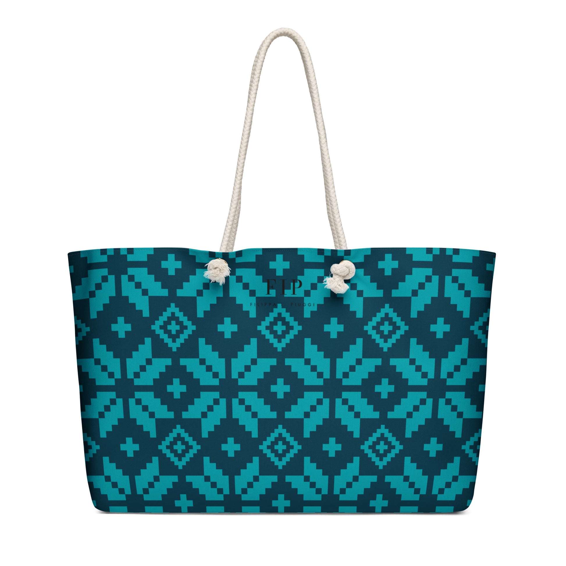 A tote bag with aztec pattern in teal and dark blue, featuring off-white rope handles. 