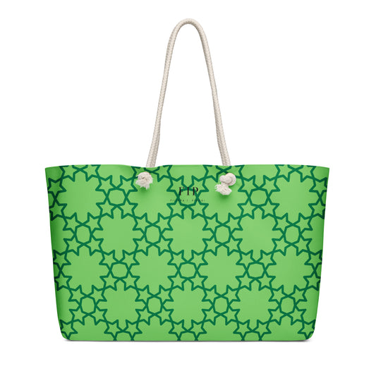 A bright green tote bag with a dark green geometric trellis pattern and thick off-white rope handles. 