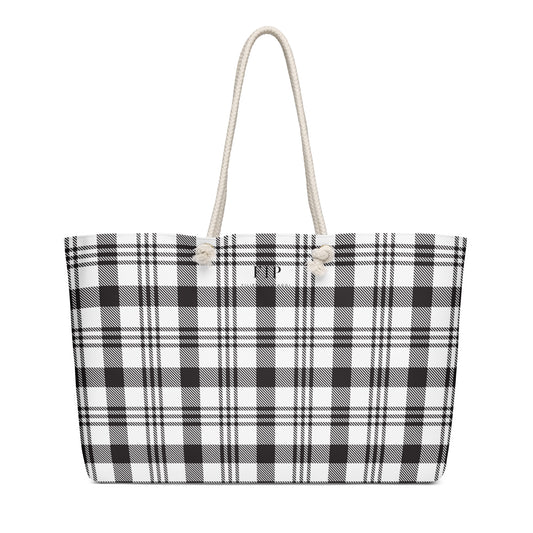 A tote bag with a black and white plaid pattern and thick cream rope handles.