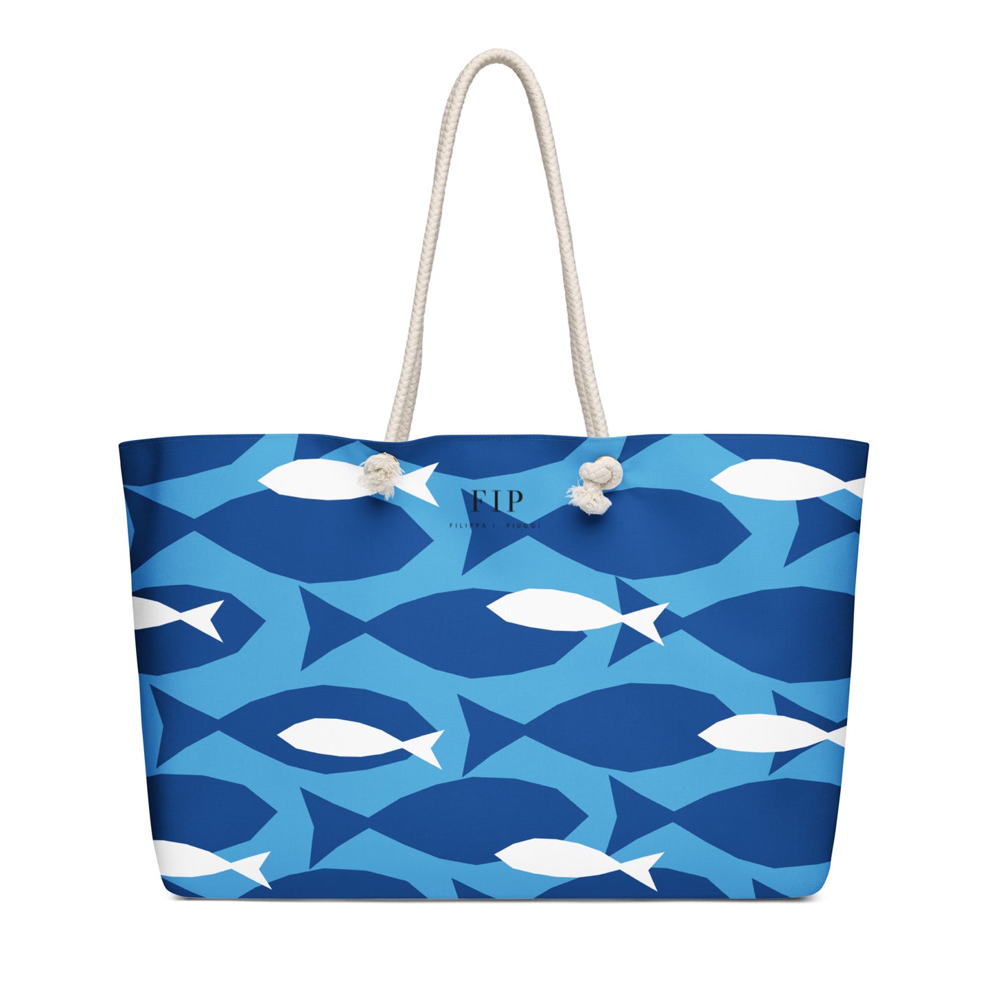 A tote bag with a blue and white fish pattern, featuring two cream-colored rope handles 