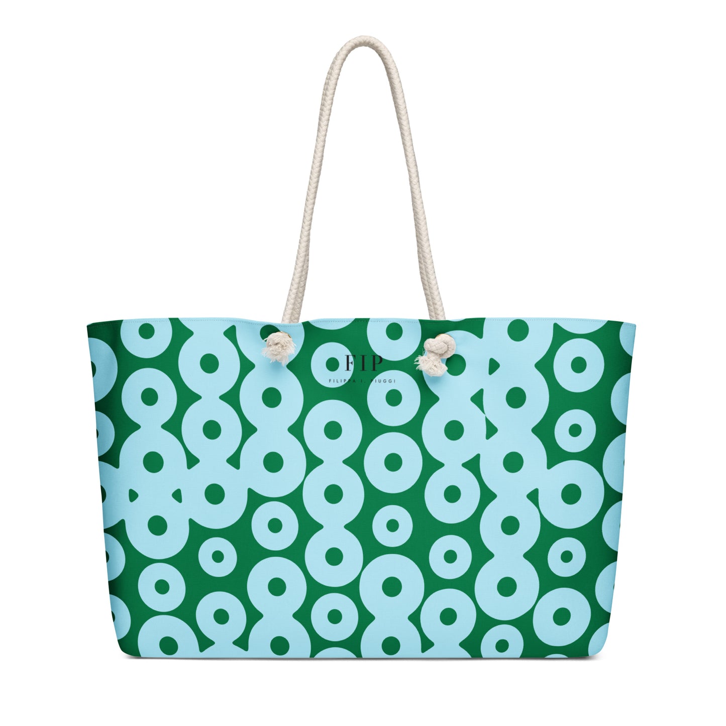 A tote bag with a green and light blue repeating circle pattern, featuring off-white rope handles 