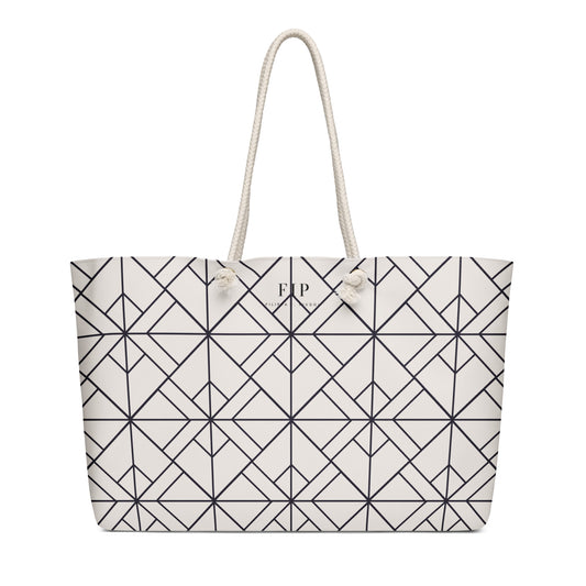 A large tote bag with a black geometric line pattern on a white background, featuring two thick white rope handles 