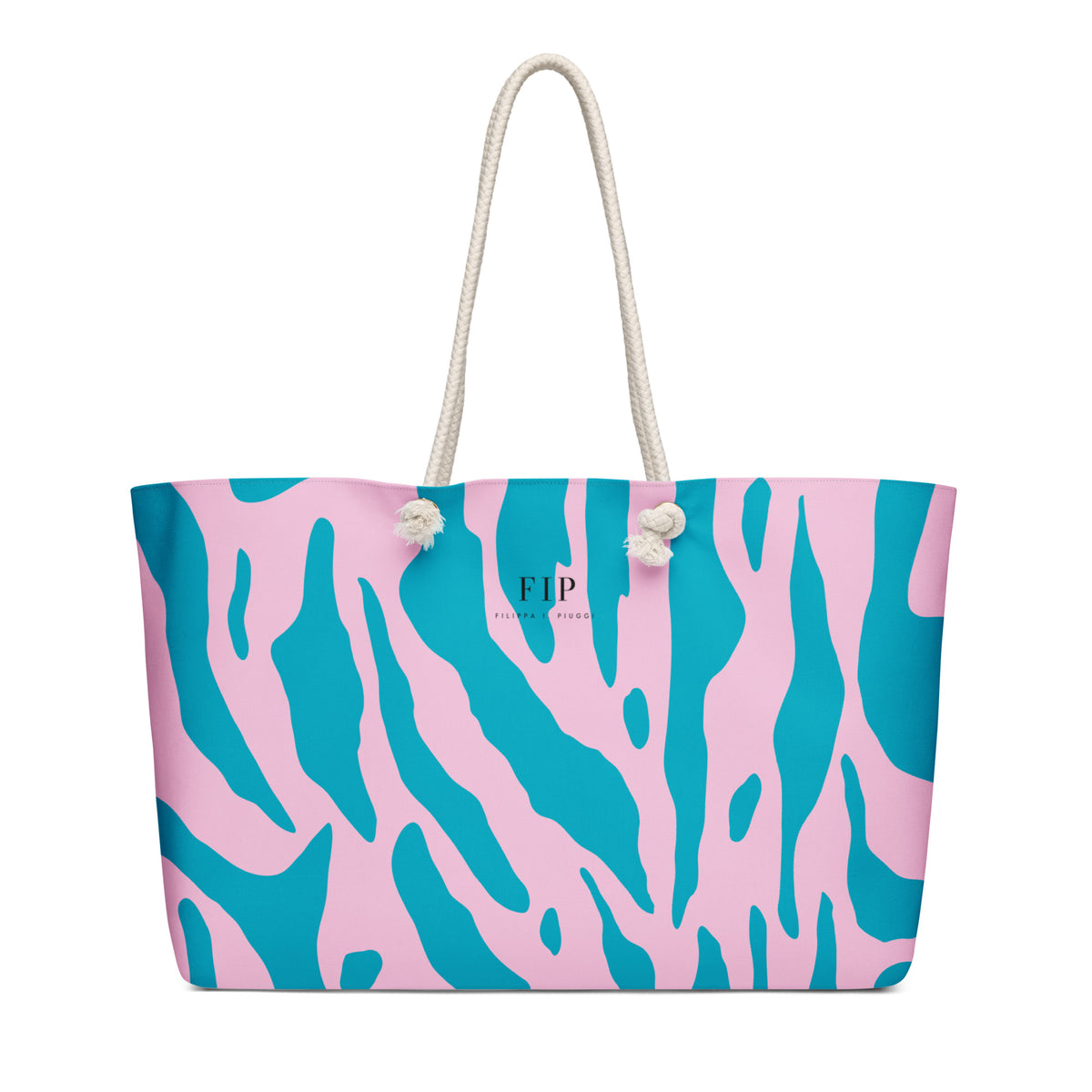 A tote bag with a pink and teal abstract pattern, featuring cream-colored rope handles